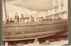 Group portrait in a beach-launched pleasure yacht, possibly the 'New Albertine', in front of the Queens Hotel, Hastings by William Smith (1910)